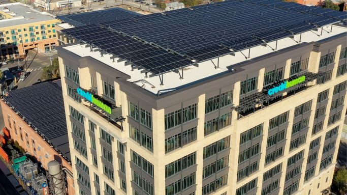Credit human building with solar panels on rooftop